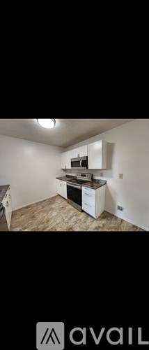 A kitchen area with a stove top oven and a microwave.