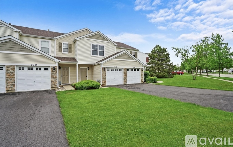 A large, well-maintained house with a driveway and garage is available for rent.