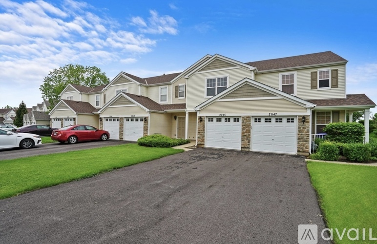 A large house with a garage and a driveway in front of it.