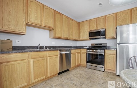 A kitchen with wooden cabinets and stainless steel appliances.
