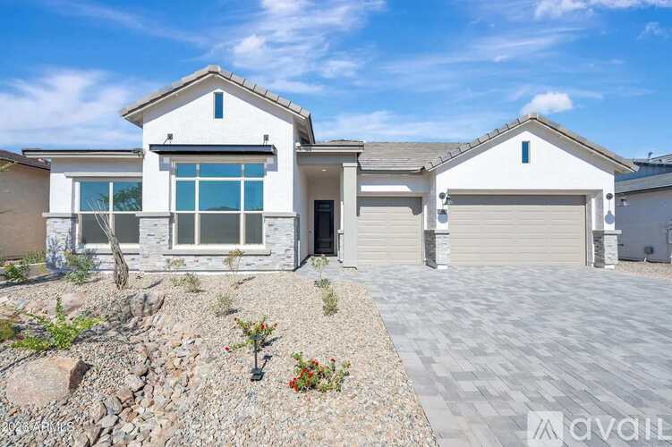 A modern house with a driveway in front.