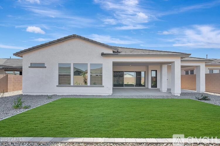 A modern house with a white exterior and a large front yard.