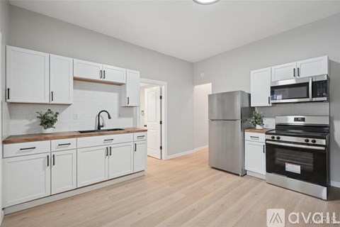 A kitchen with white cabinets and stainless steel appliances.