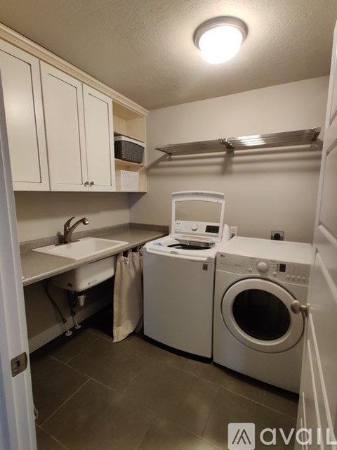 A small laundry room with a washer and dryer.