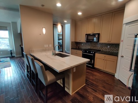 A kitchen with a long table and chairs.