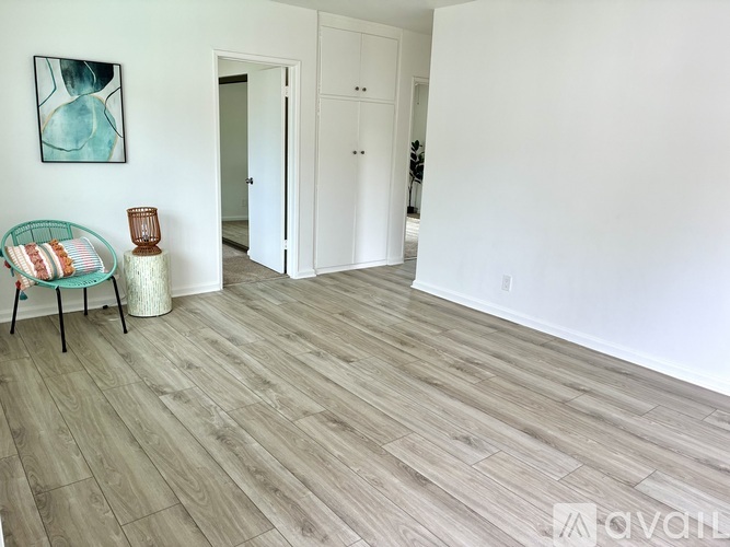A room with a wooden floor and white walls.