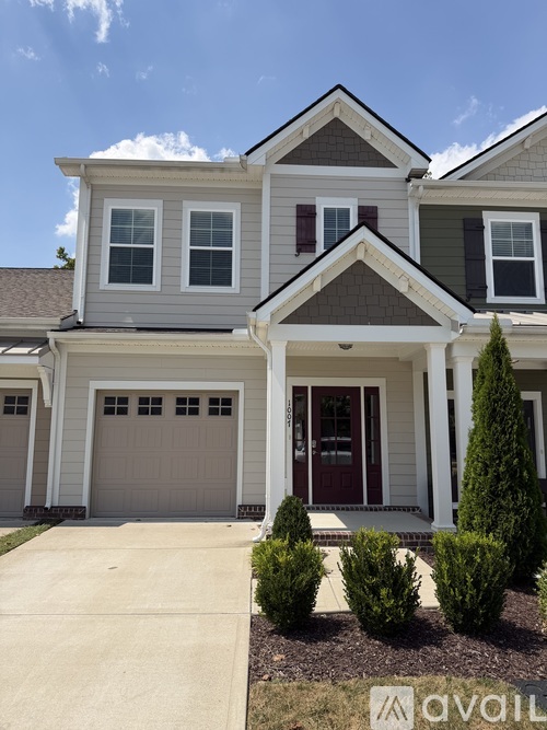 A house with a brown door and a white garage door.