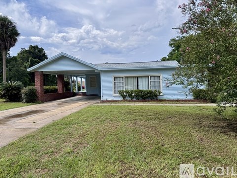 A blue house with a porch and a covered entrance.