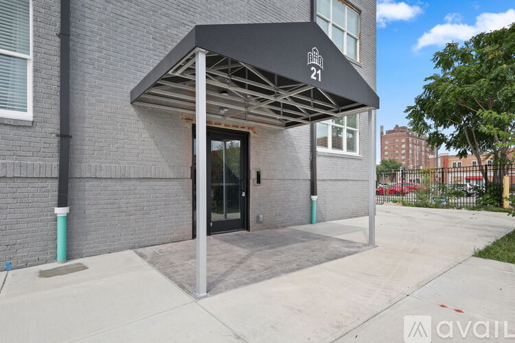 A building with a black awning and the number 21 on it.