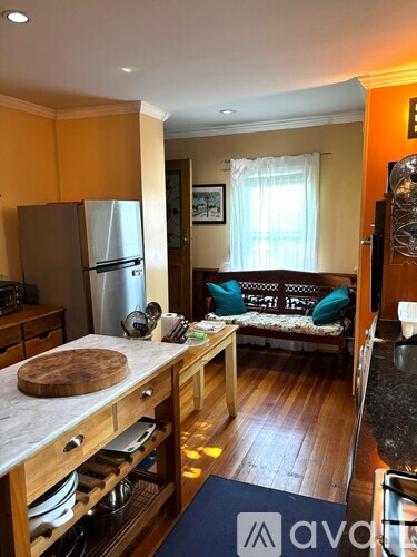 A kitchen with wooden cabinets and a refrigerator.