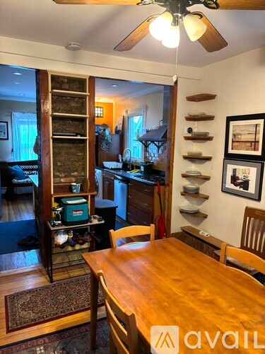 A dining room with a wooden table and chairs.