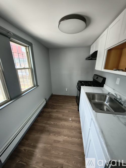 A kitchen with a sink and a window.