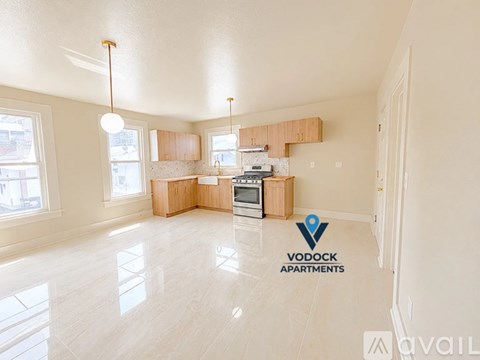 A spacious apartment with a kitchen and living room area.