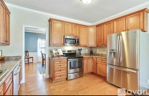 A kitchen with wooden cabinets and stainless steel appliances.
