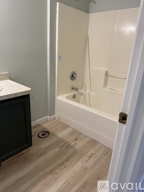 A bathroom with a white tub and a white sink.