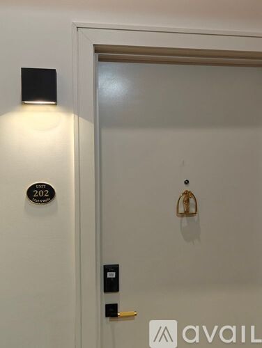 A white door with a lock and a sign on it.