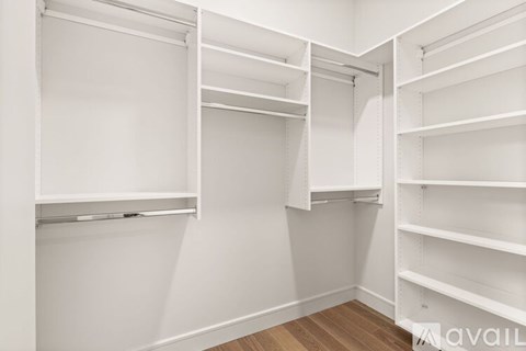 A white closet with shelves and hanging space.