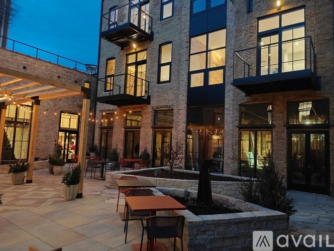A modern building with a patio and outdoor furniture.