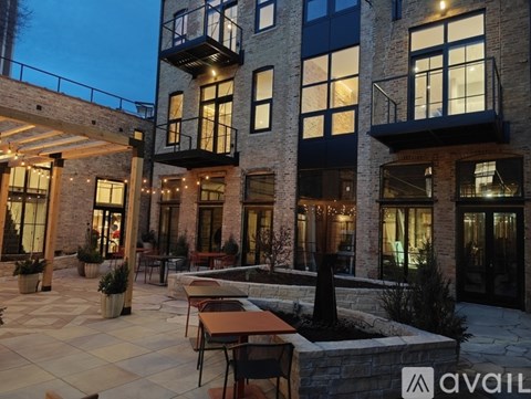A modern building with a patio and outdoor furniture.