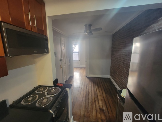 A kitchen with a stove and a refrigerator.