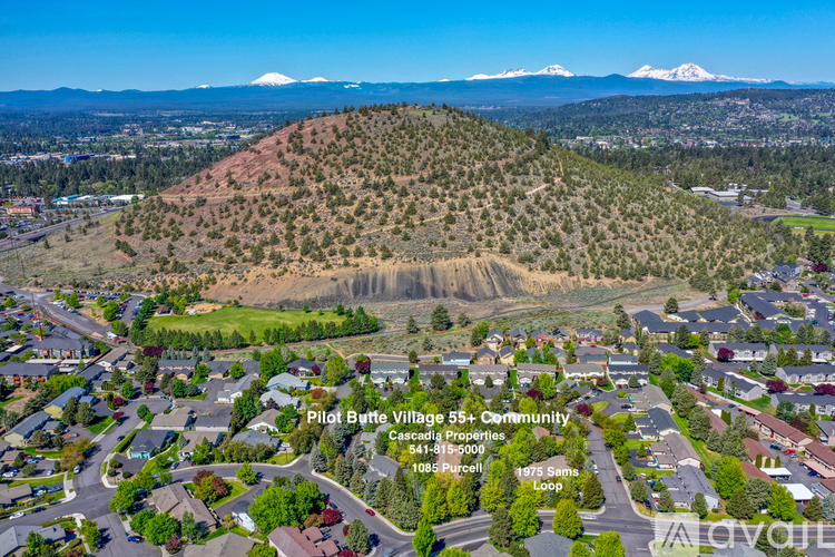 A bird's eye view of a residential area with Pilot Butte Village 55+ Community in the foreground.