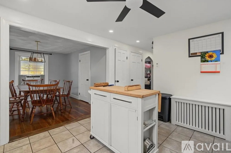 A kitchen with a wooden table and chairs.
