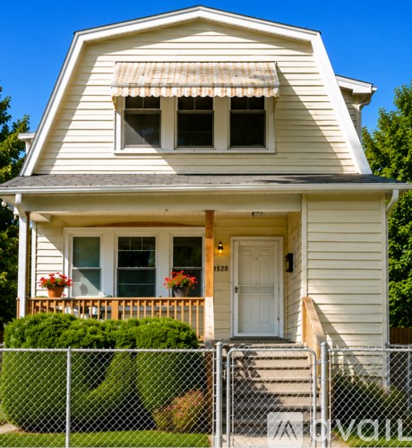 A house with a white door and windows is for sale.