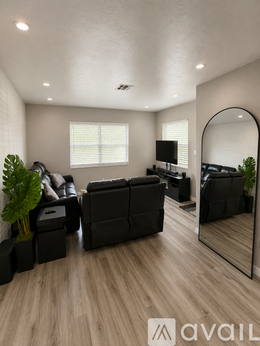 A living room with a large mirror and a TV.