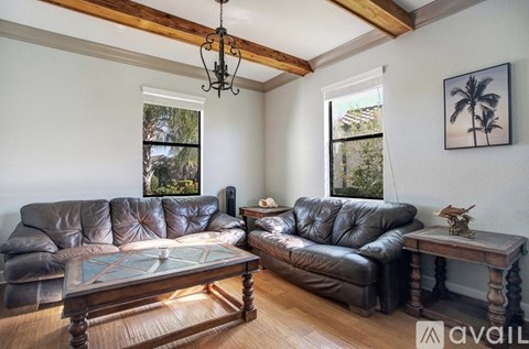 A living room with two leather sofas and a coffee table.