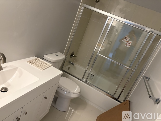 A white toilet sits next to a sink in a bathroom.