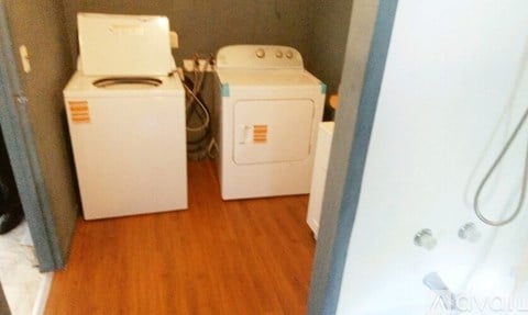 A small bathroom with a toilet and a washing machine.