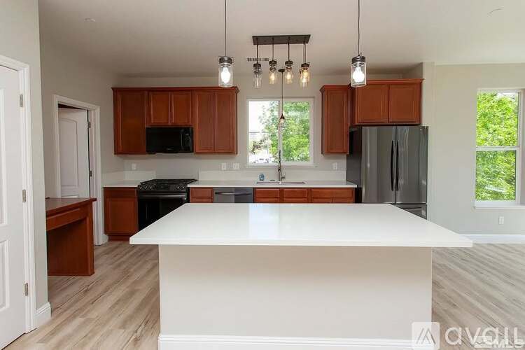 A kitchen with a white island in the middle.