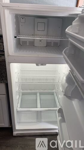 A white refrigerator with the door open and shelves visible.