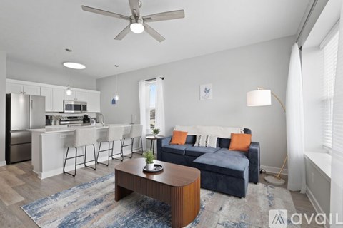 A living room with a blue couch and a wooden coffee table.