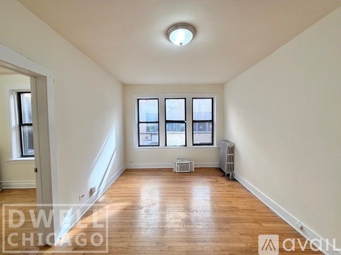A room with wooden floors and a skylight.