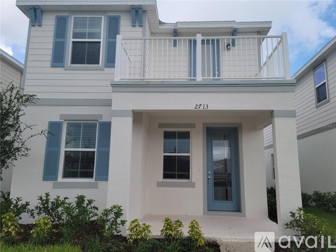 A two-story house with a balcony on the second floor.