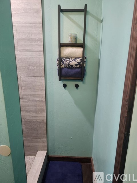 A bathroom with a towel rack and a toilet.