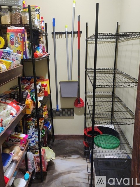 A storage room with shelves and racks filled with various items.