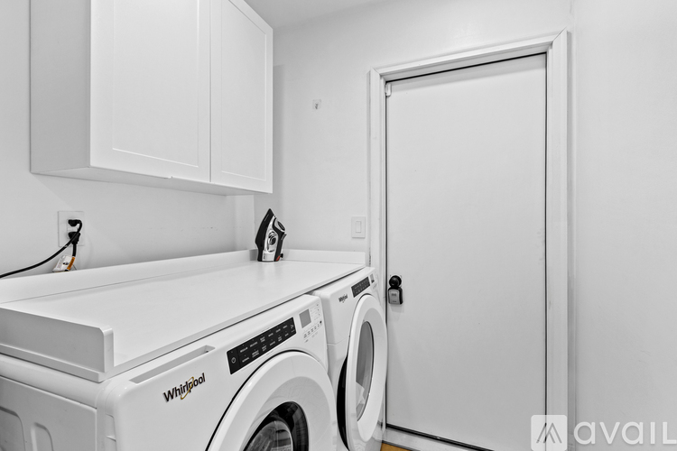 A Whirlpool washing machine and dryer in a laundry room.