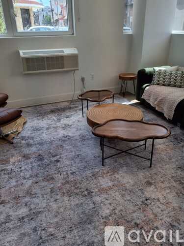 A room with a couch, a table, and a window.