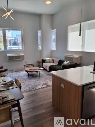 A living room with a couch, chair, and table.