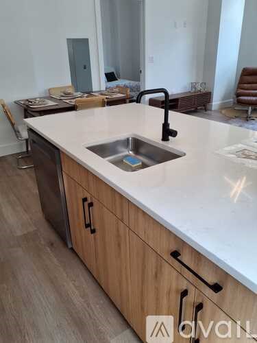 A kitchen with a sink and wooden cabinets.
