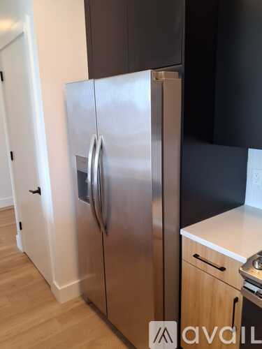 A stainless steel refrigerator in a kitchen.