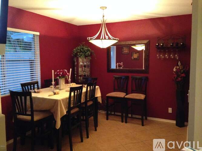 A dining room with a white table and chairs.