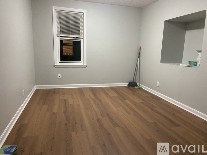 A room with wooden flooring and a window.