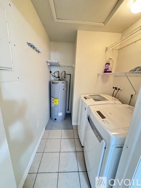 A small laundry room with a washer and dryer.