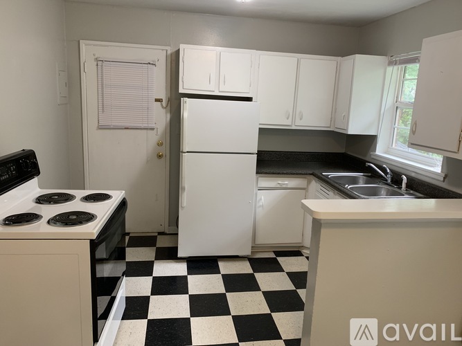 A kitchen with black and white checkered floor.