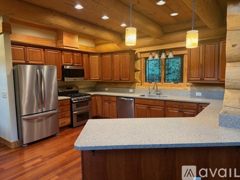 A kitchen with wooden cabinets and a granite countertop.
