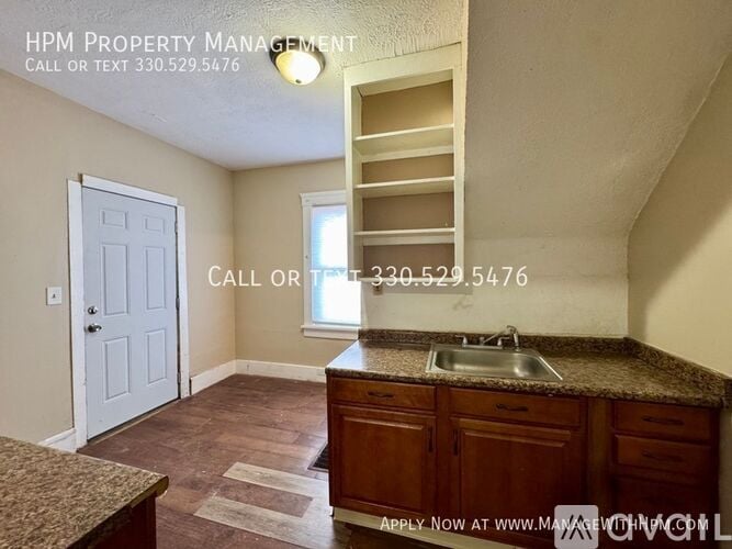 A kitchen area with a sink and a window.