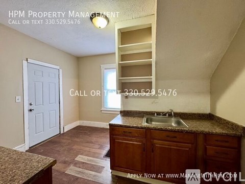A kitchen area with a sink and a window.